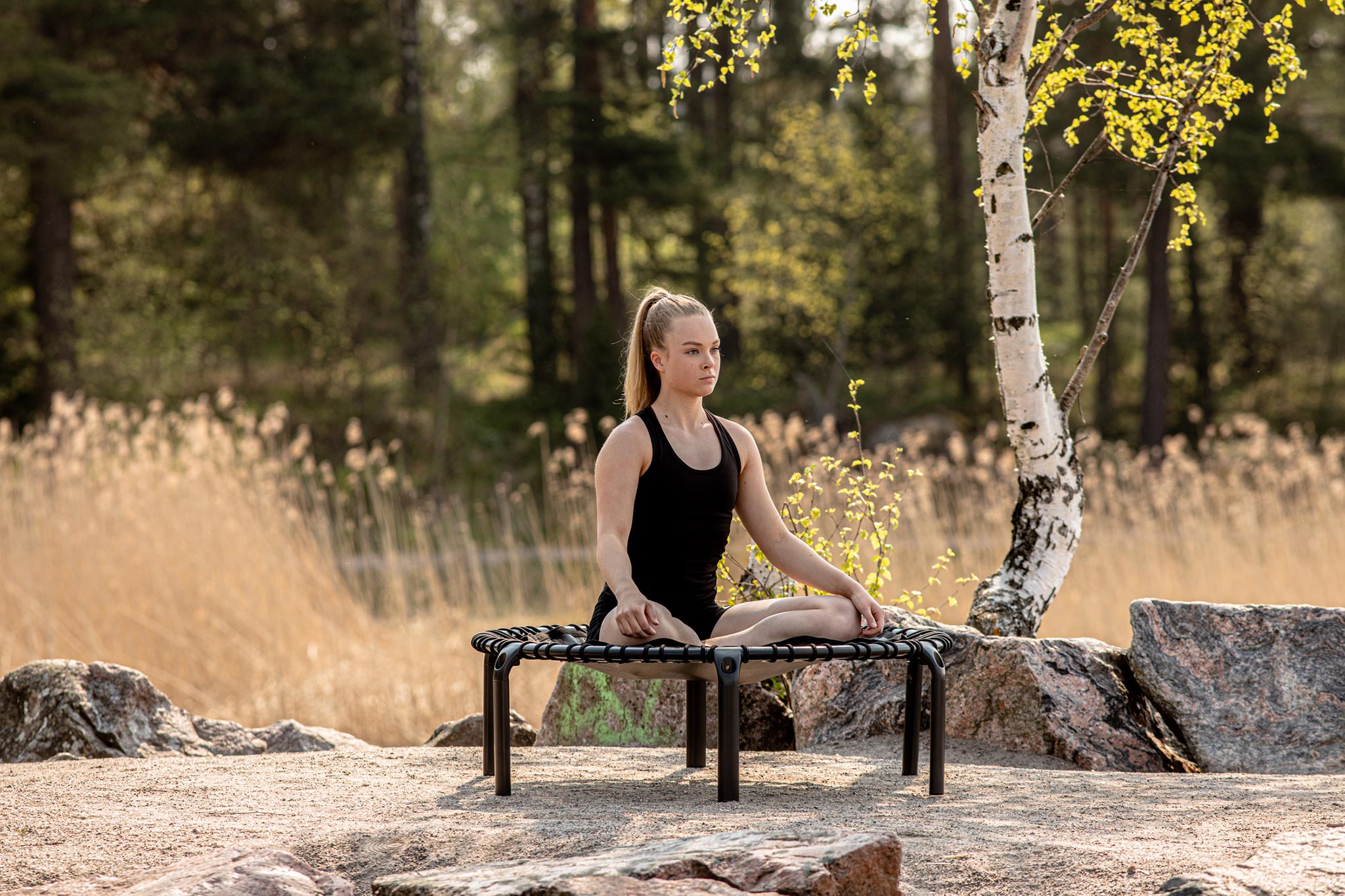 Yoga utomhus på en fitness trampolin